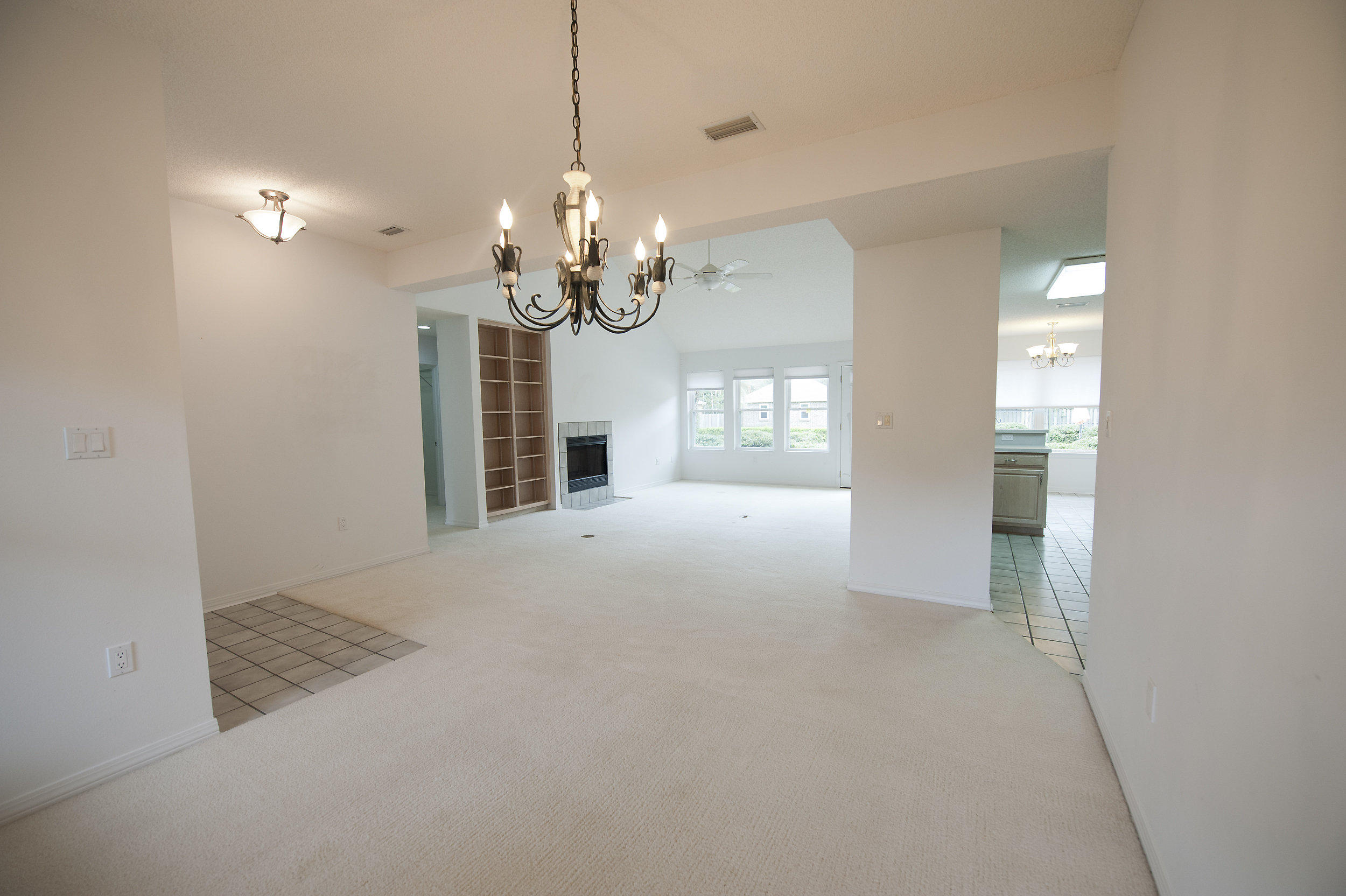 2557 Crescent Road Navarre, FL 32566 - Photo 26 of 48 a view of a livingroom with a chandelier fan and windows