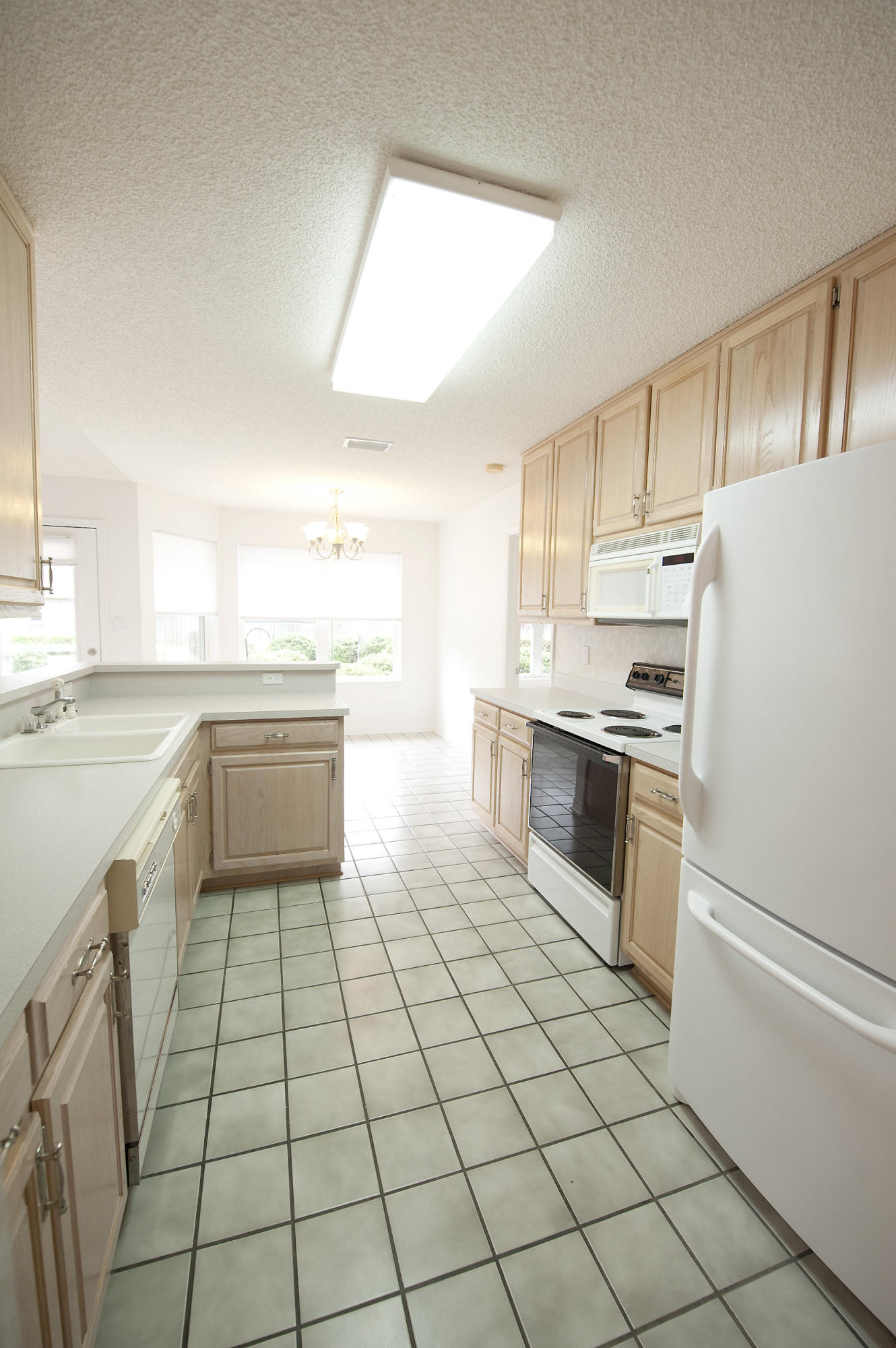 2557 Crescent Road Navarre, FL 32566 - Photo 30 of 48 a kitchen with a stove a sink and a refrigerator