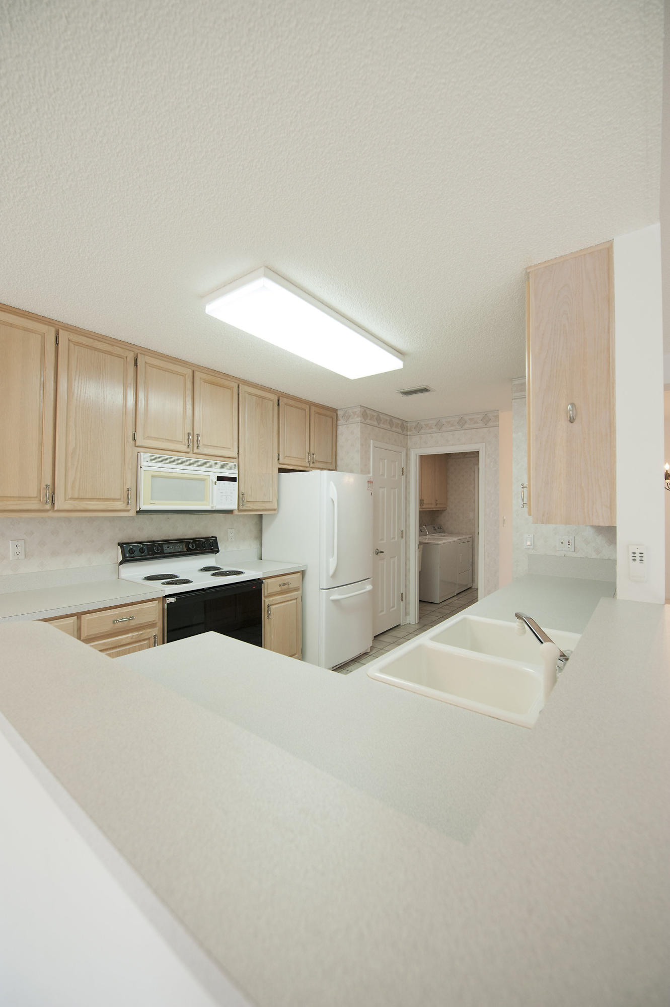 2557 Crescent Road Navarre, FL 32566 - Photo 32 of 48 a kitchen with stainless steel appliances a refrigerator and white cabinets