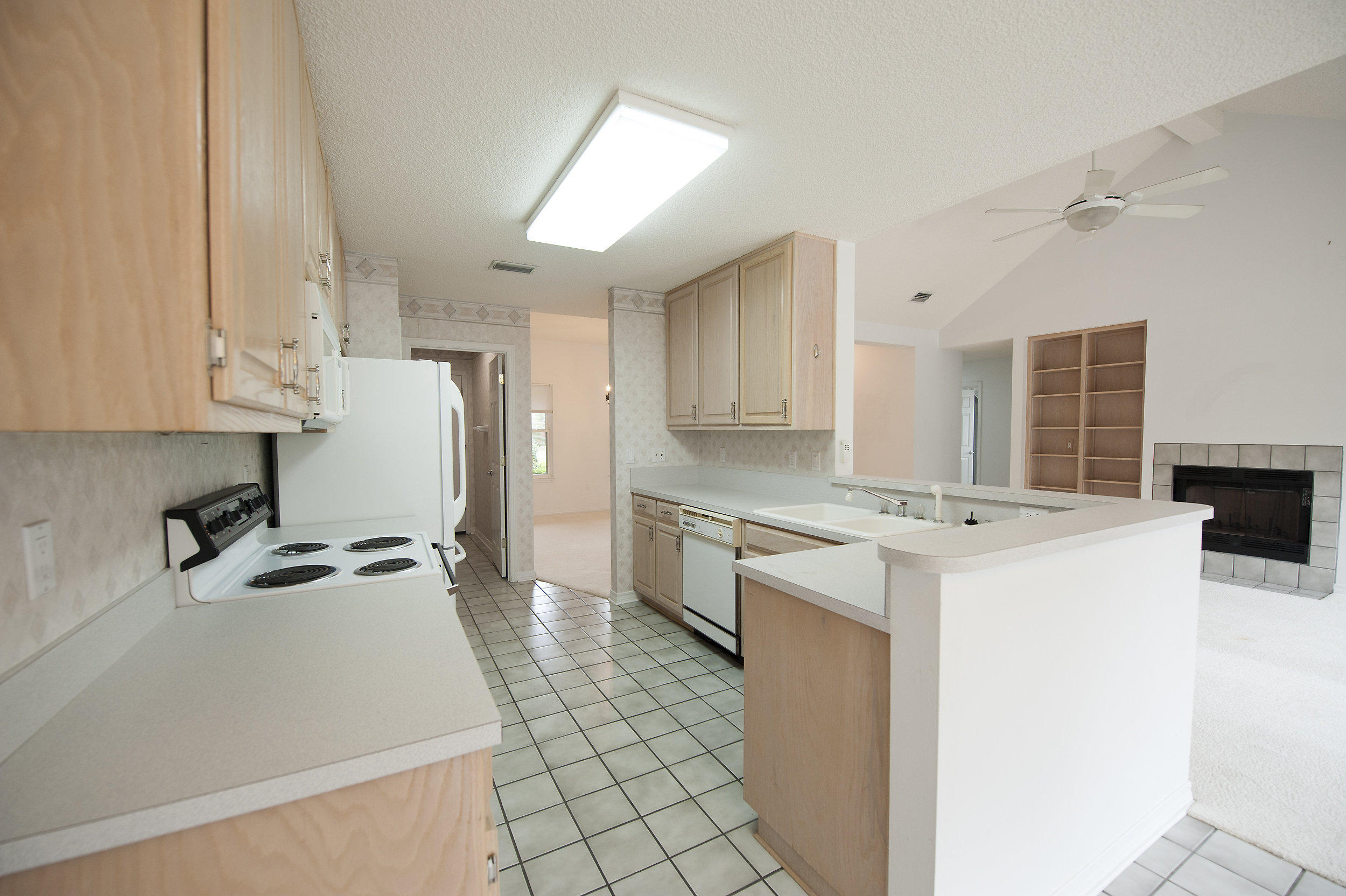 2557 Crescent Road Navarre, FL 32566 - Photo 34 of 48 a kitchen with a sink a stove a refrigerator and cabinets