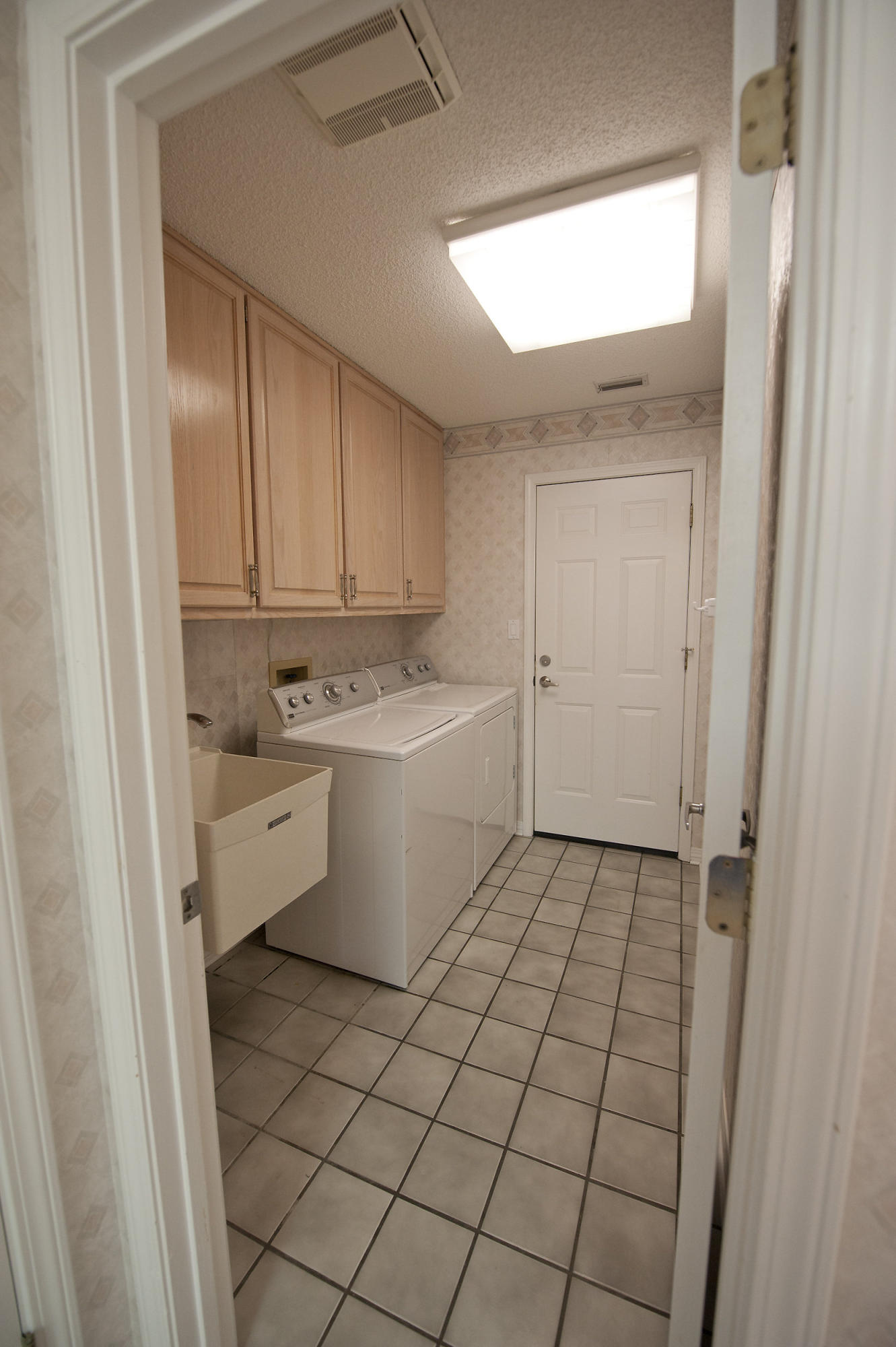 2557 Crescent Road Navarre, FL 32566 - Photo 35 of 48 a utility room with cabinets washer and dryer
