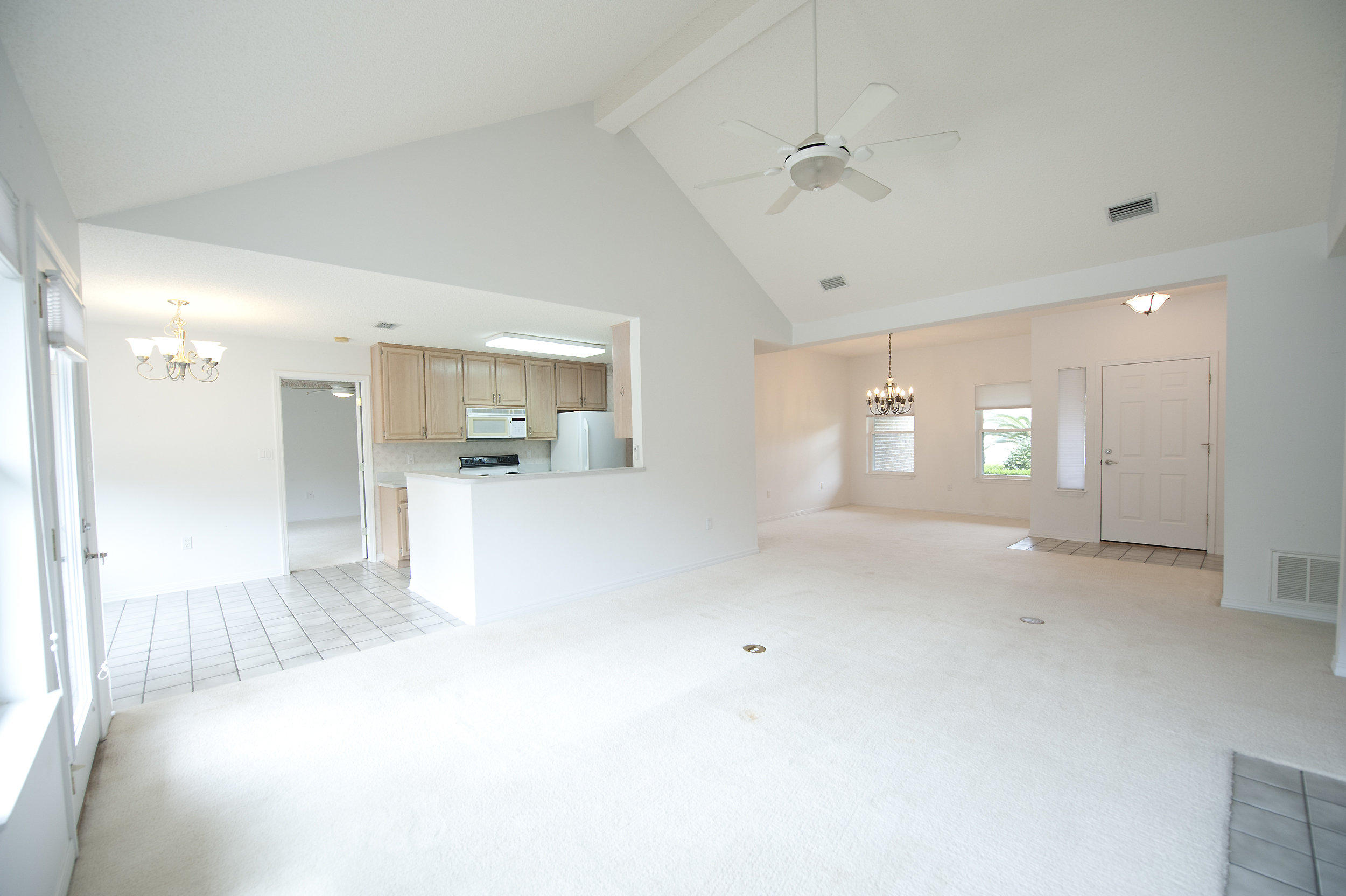 2557 Crescent Road Navarre, FL 32566 - Photo 37 of 48 a view of a big room with wooden floor and a kitchen
