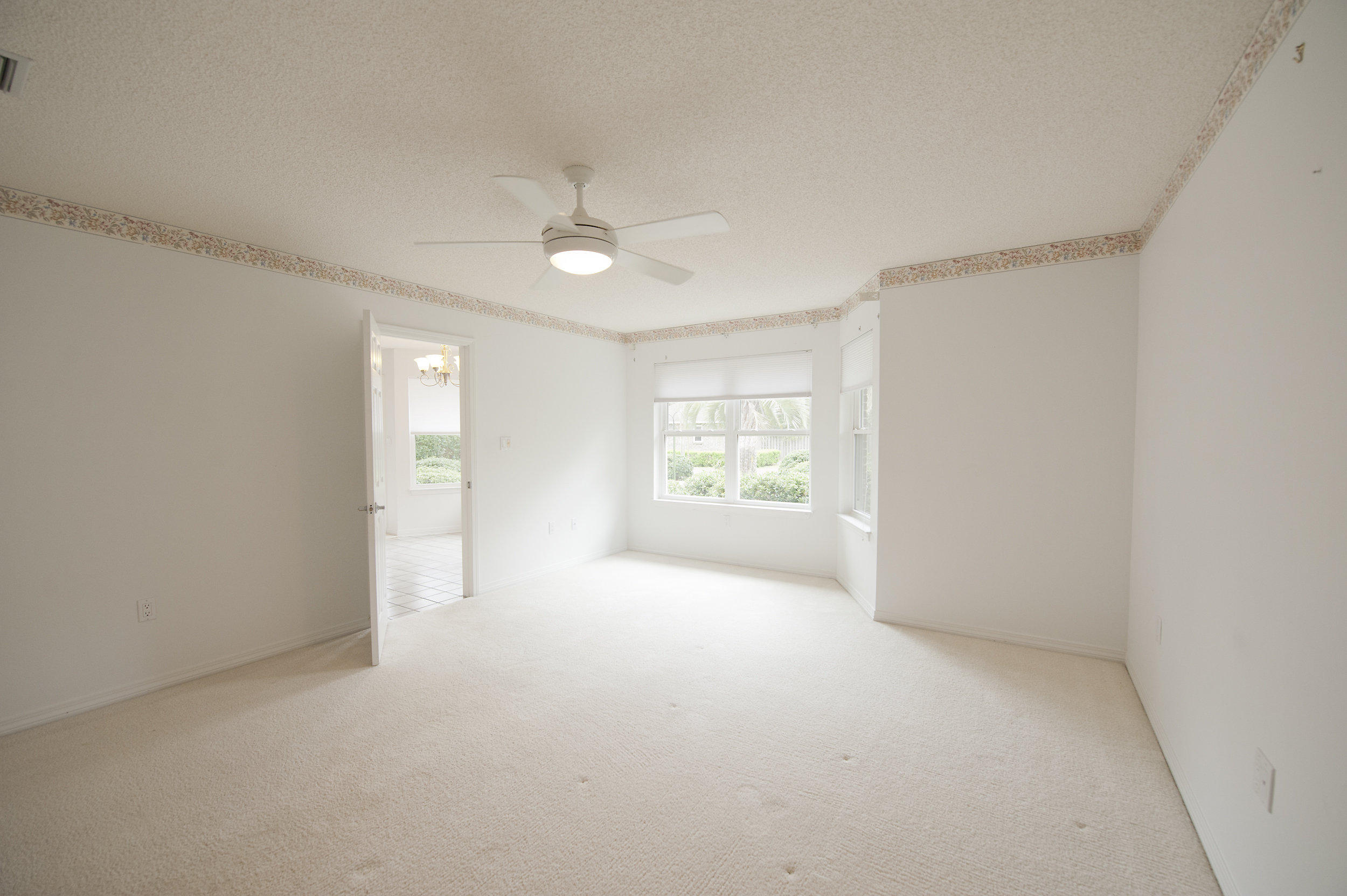 2557 Crescent Road Navarre, FL 32566 - Photo 42 of 48 an empty room with windows and fan