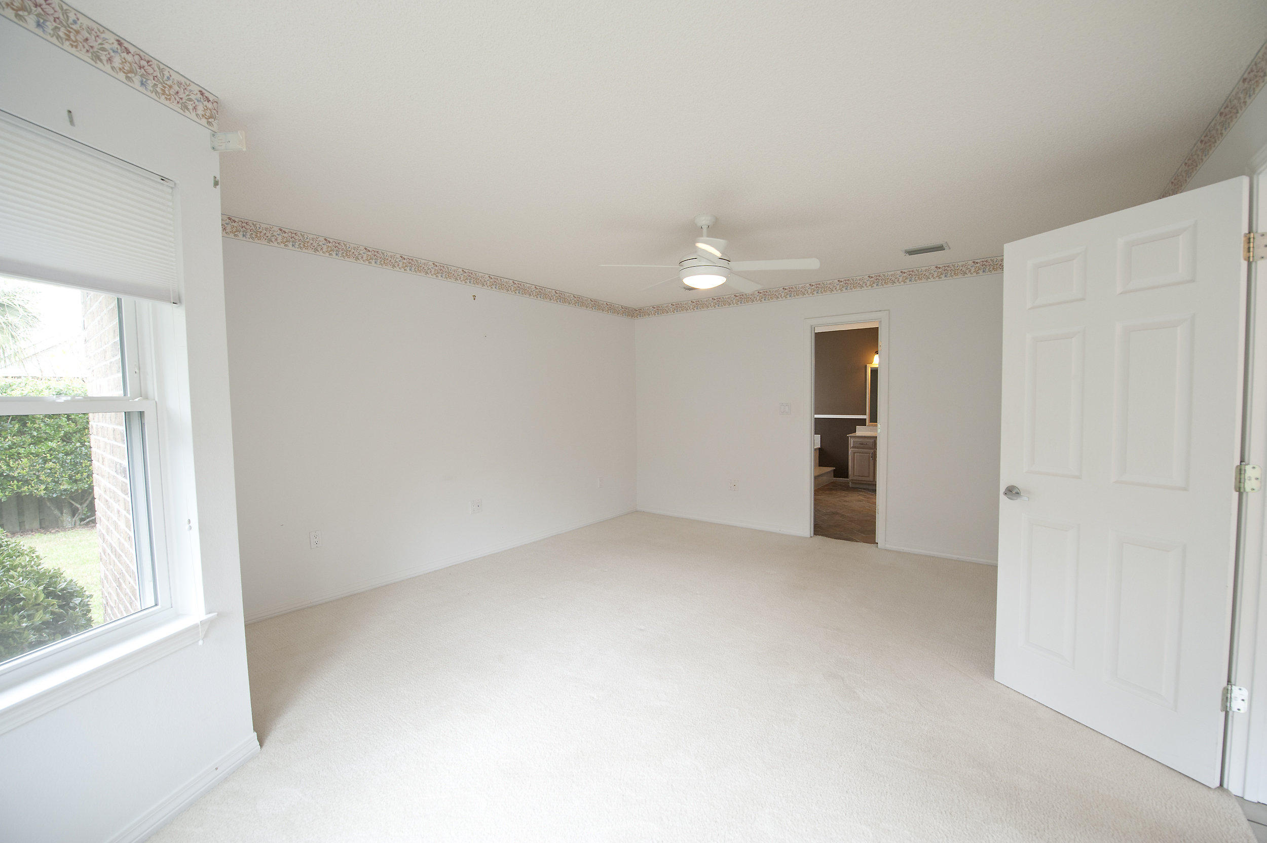 2557 Crescent Road Navarre, FL 32566 - Photo 43 of 48 an empty room with a window and a kitchen