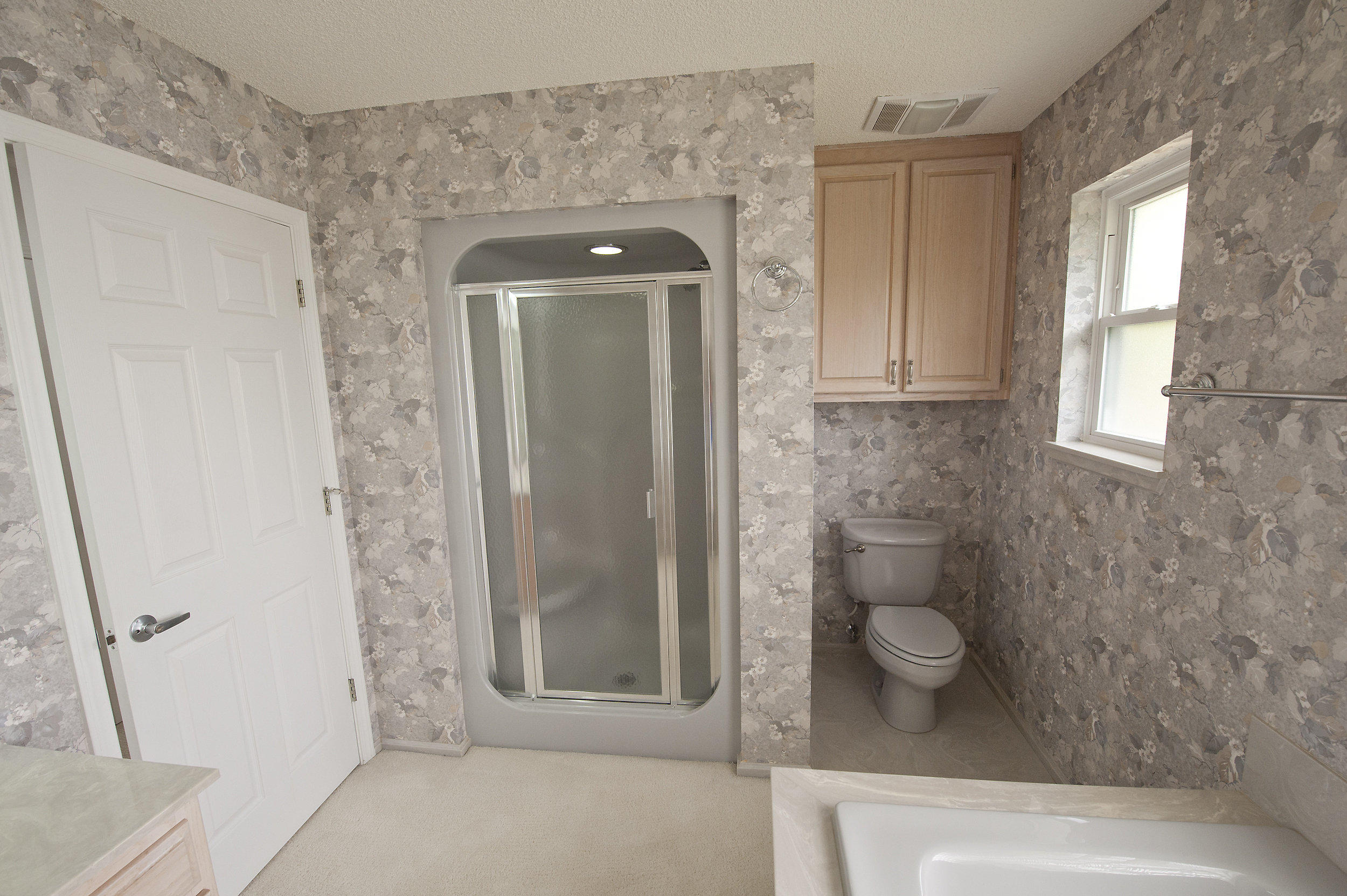 2557 Crescent Road Navarre, FL 32566 - Photo 46 of 48 a bathroom with a glass shower door