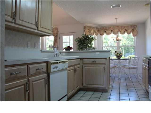 2557 Crescent Road Navarre, FL 32566 - Photo 5 of 48 a kitchen with a sink window and cabinets