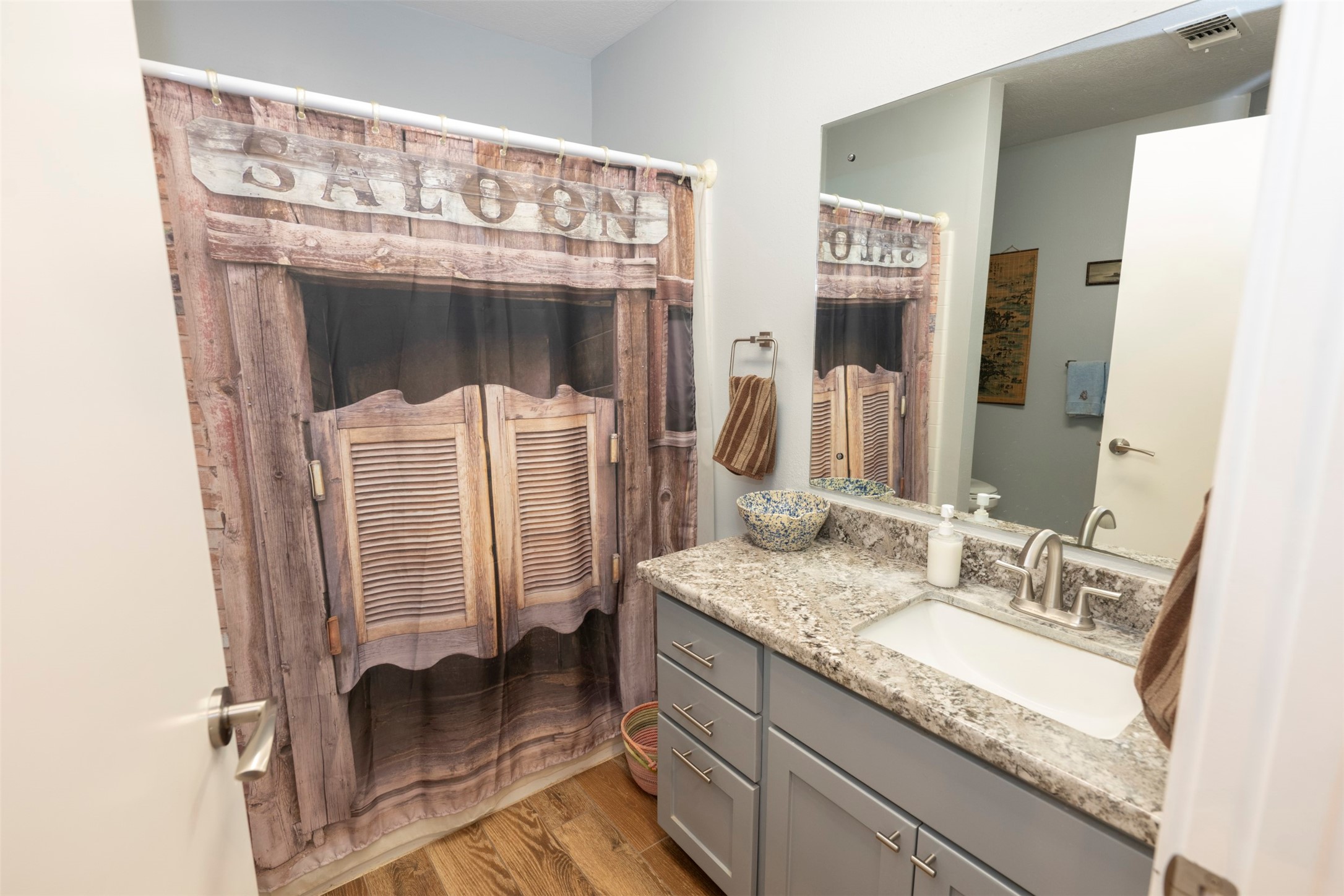 8775 Lone Star Road Washington, TX 77880 - Photo 19 of 44 a bathroom with a granite countertop sink a mirror and shower