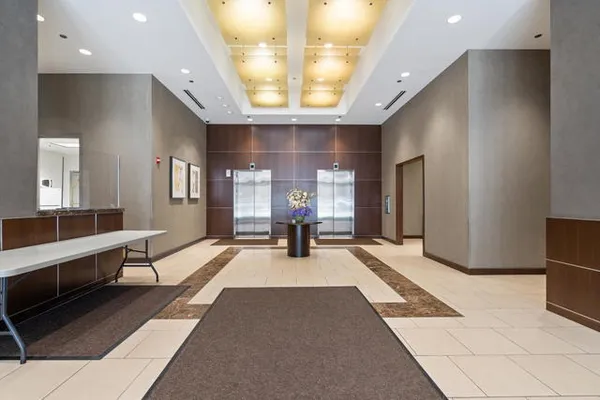 a large room with lots of windows and couches