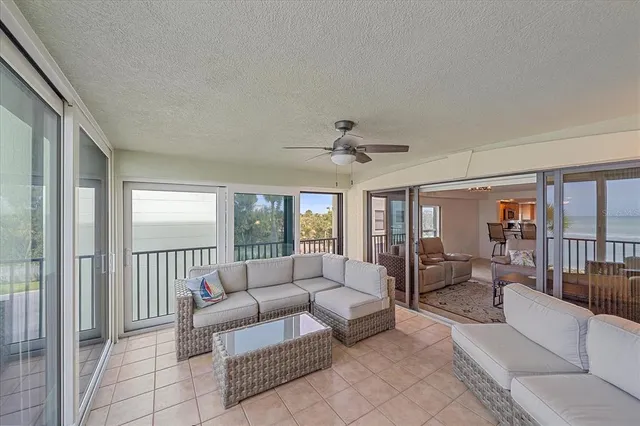 a living room with furniture and large windows