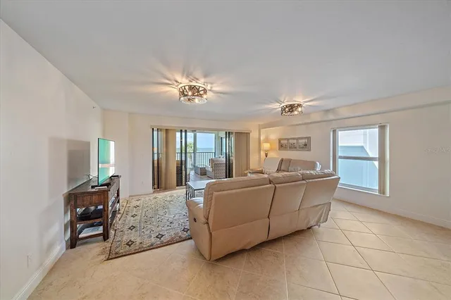 a large kitchen with kitchen island a large counter top space a sink stainless steel appliances and cabinets