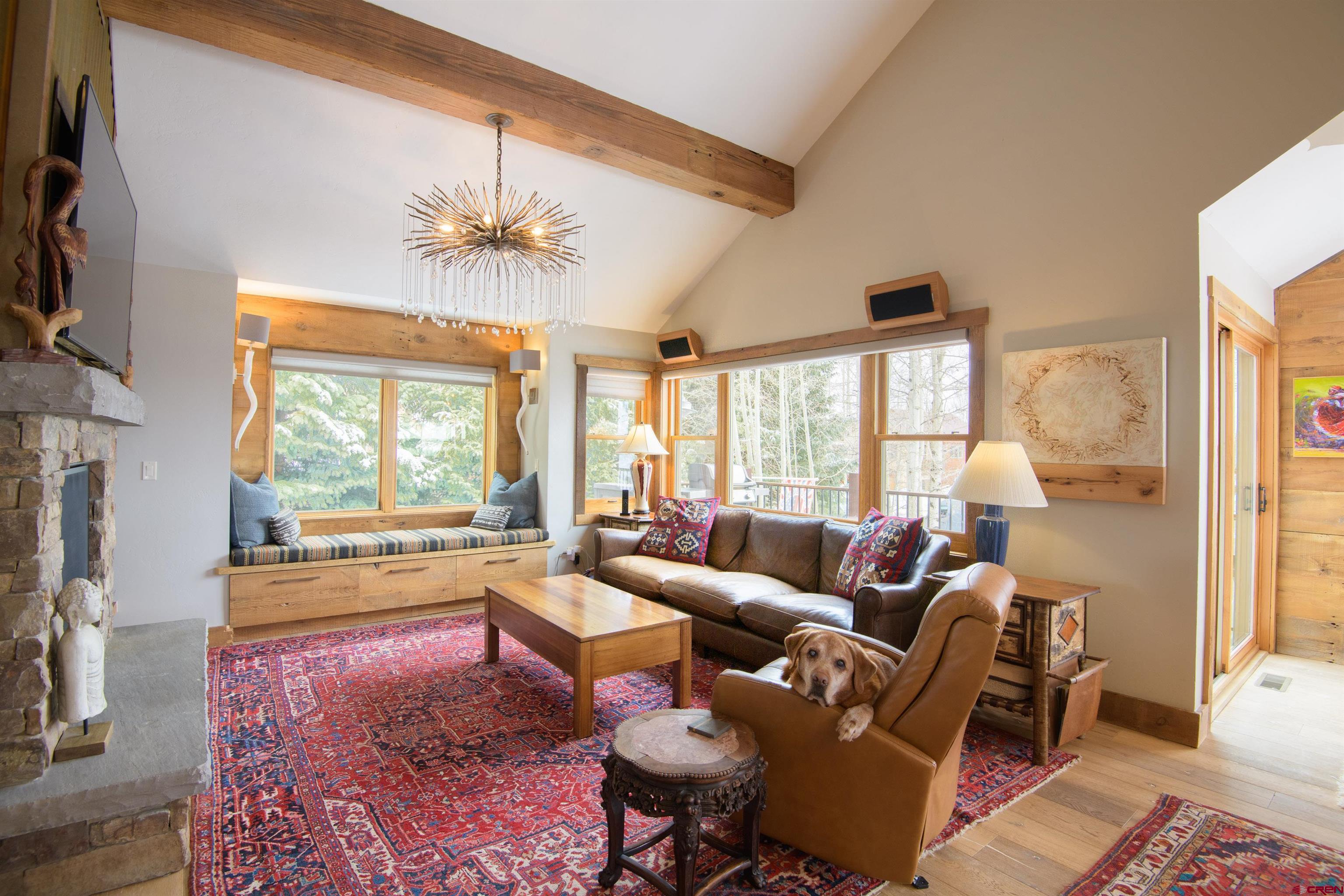 722 Elk Avenue Crested Butte, CO 81224 - Photo 12 of 32 a living room with furniture fireplace and a large window