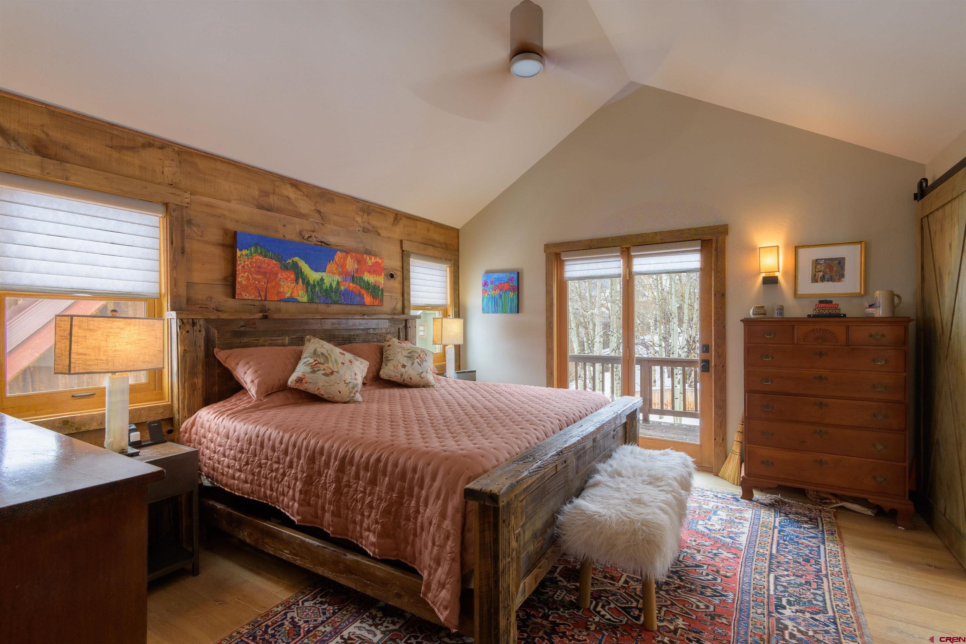 722 Elk Avenue Crested Butte, CO 81224 - Photo 15 of 32 a bedroom with a bed and wooden floor