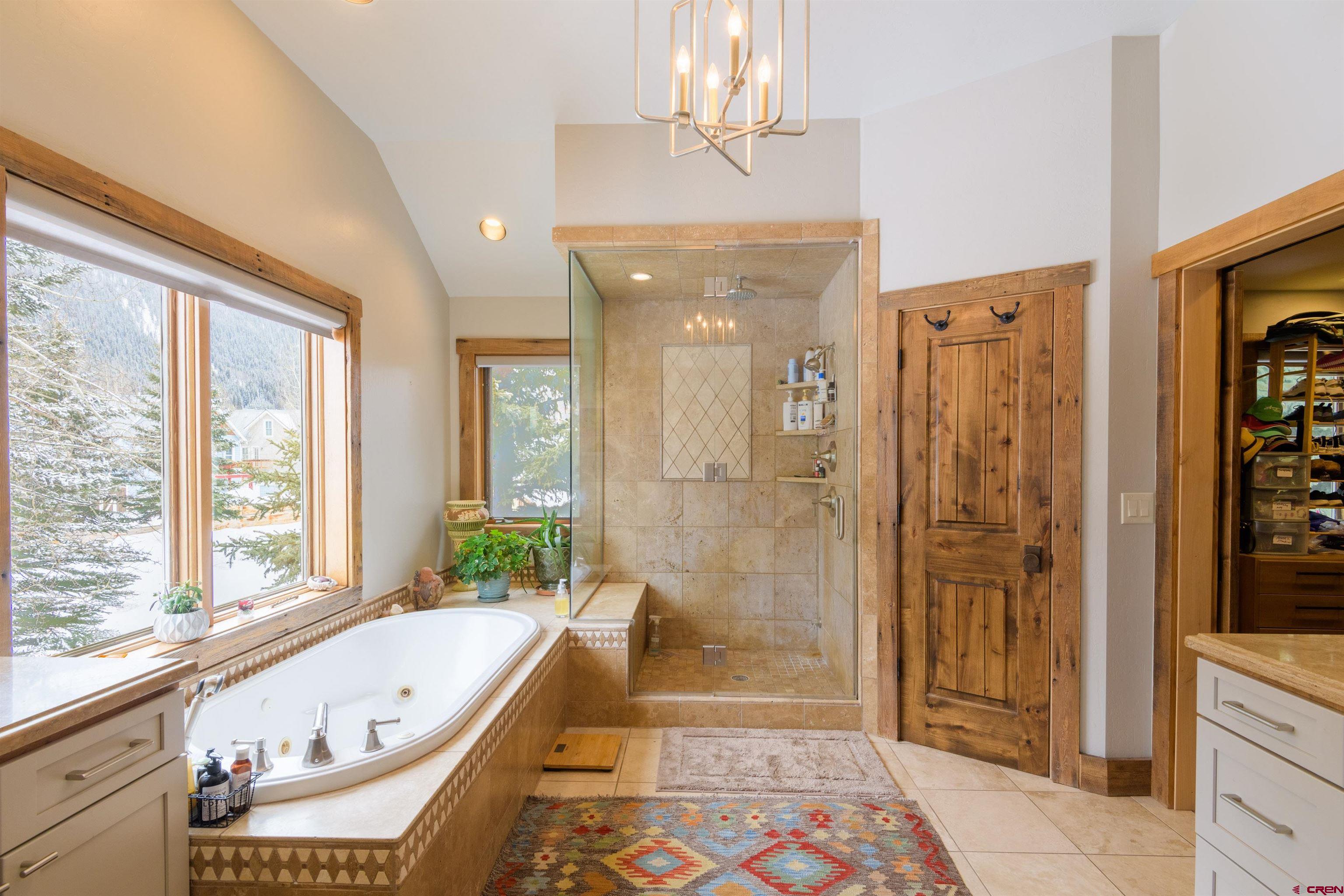 722 Elk Avenue Crested Butte, CO 81224 - Photo 16 of 32 a bathroom with a tub shower and sink