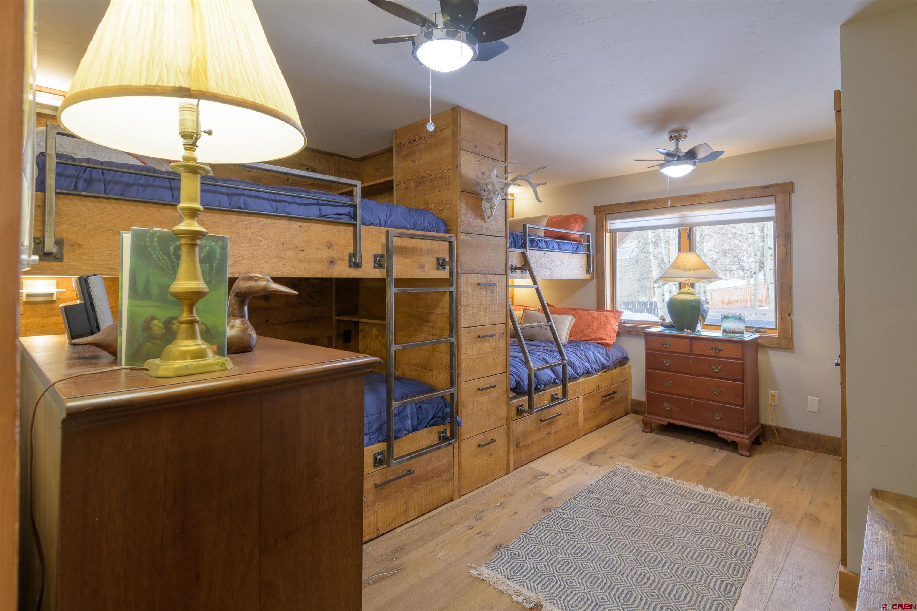 722 Elk Avenue Crested Butte, CO 81224 - Photo 21 of 32 a living room with a couch chairs and a chandelier