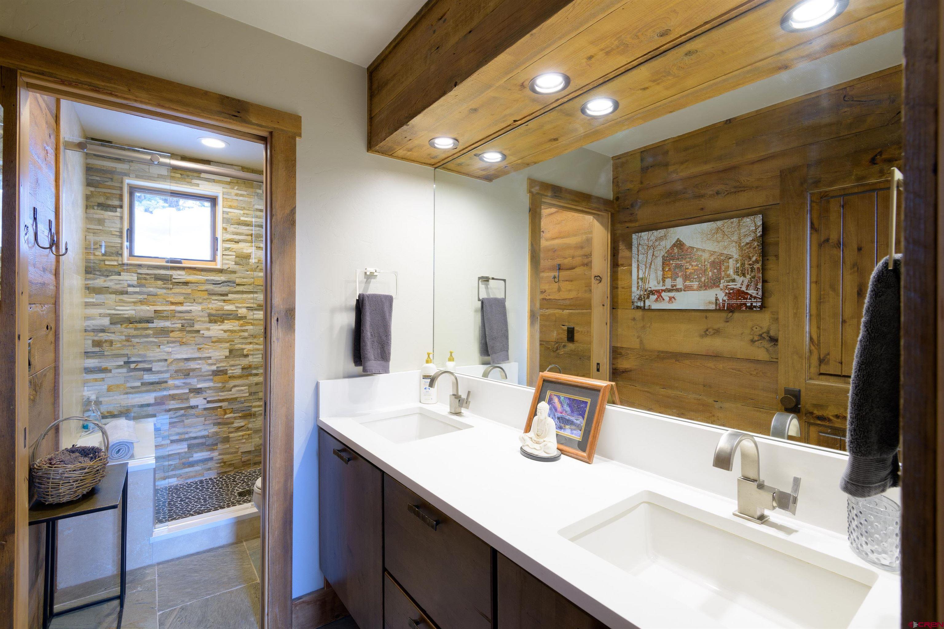 722 Elk Avenue Crested Butte, CO 81224 - Photo 24 of 32 a bathroom with a sink vanity and a mirror