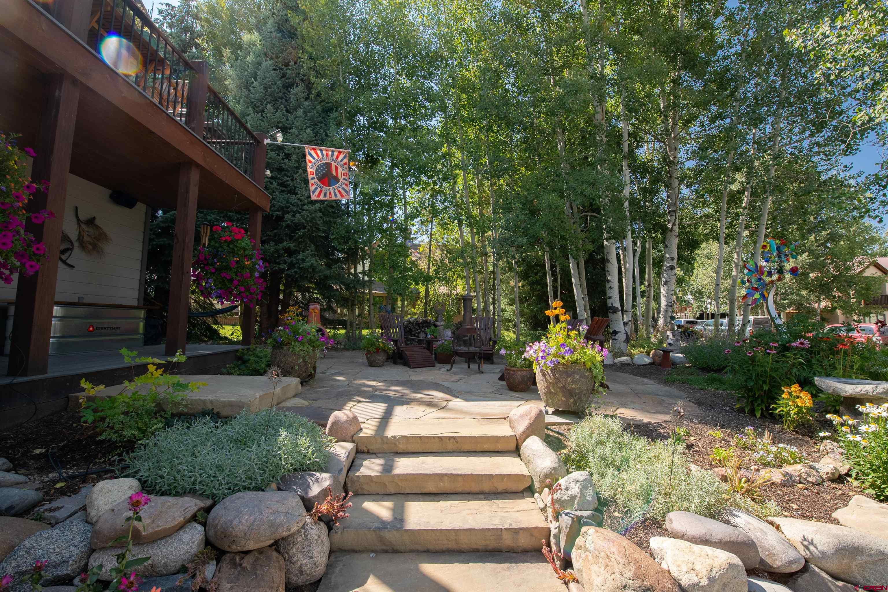 722 Elk Avenue Crested Butte, CO 81224 - Photo 3 of 32 a view of a park with plants and a bench