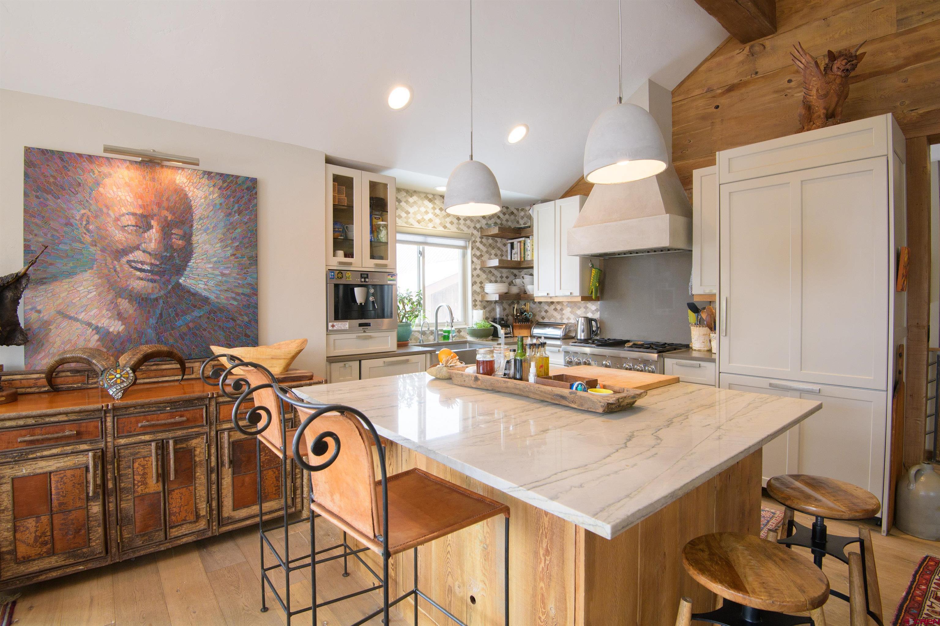 722 Elk Avenue Crested Butte, CO 81224 - Photo 9 of 32 a kitchen with a sink a stove and chairs