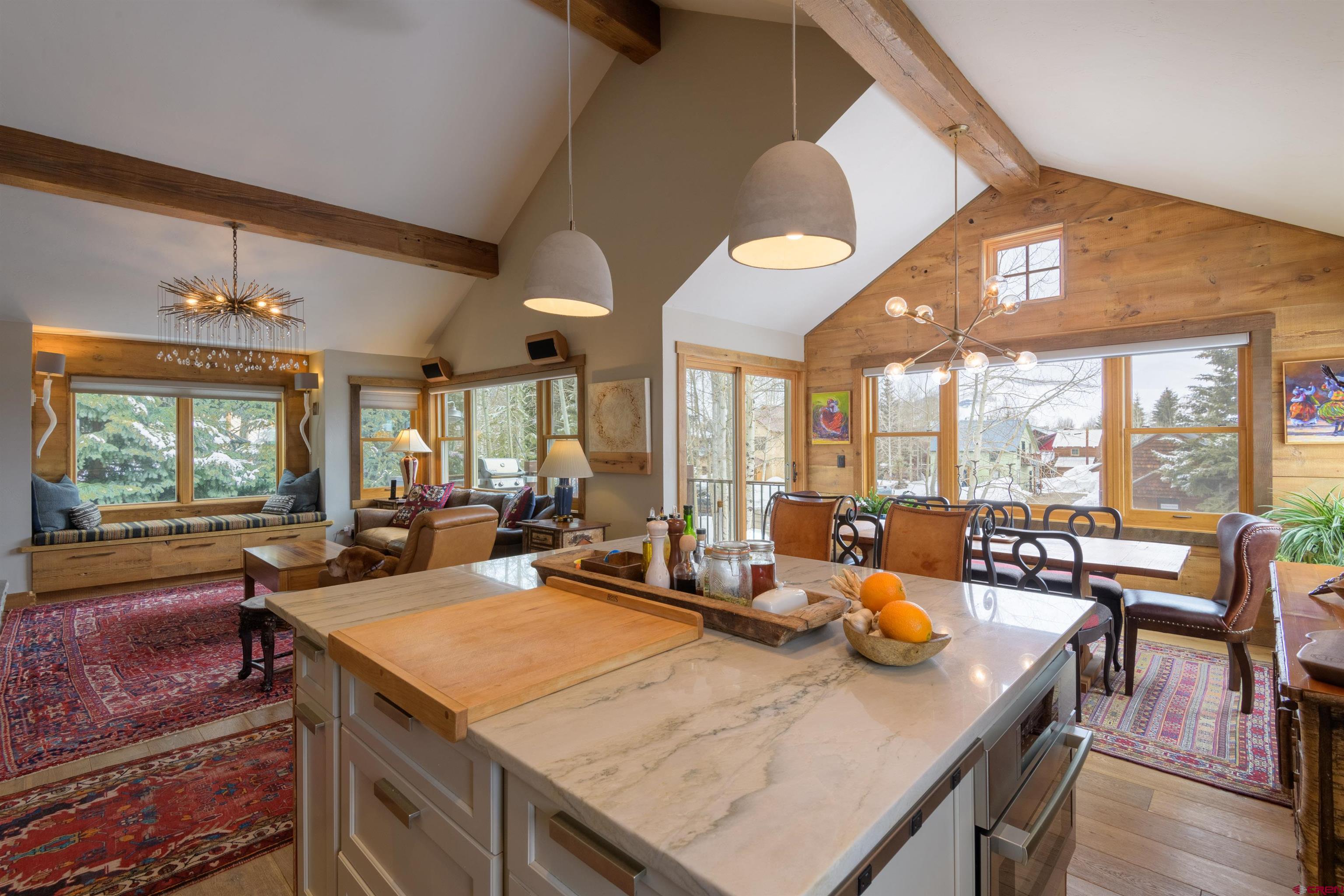 722 Elk Avenue Crested Butte, CO 81224 - Photo 10 of 32 a view of a dining room with furniture large windows and wooden floor