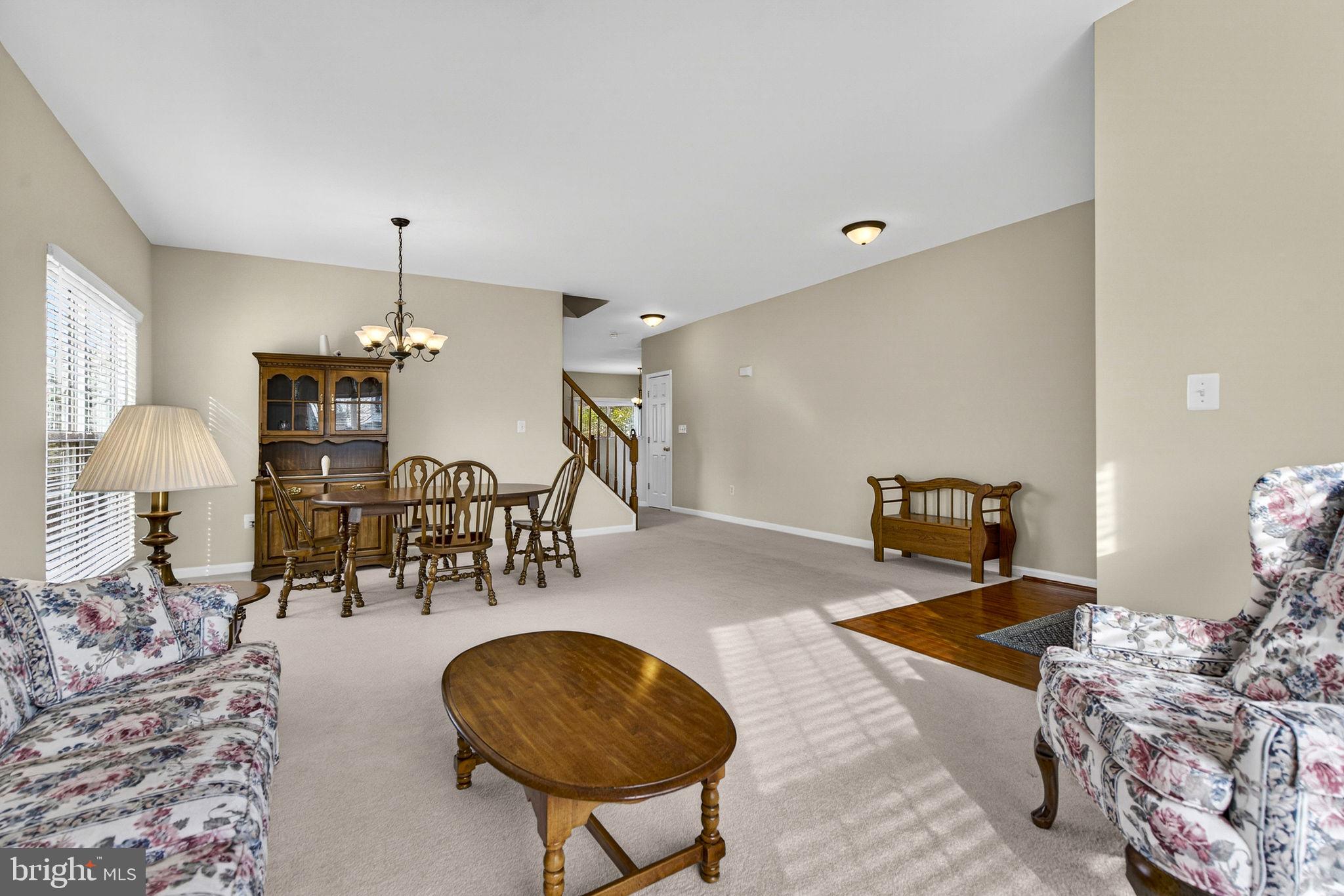 742 Blossom Tree Road Culpeper, VA 22701 - Photo 13 of 60 a living room with furniture and a chandelier