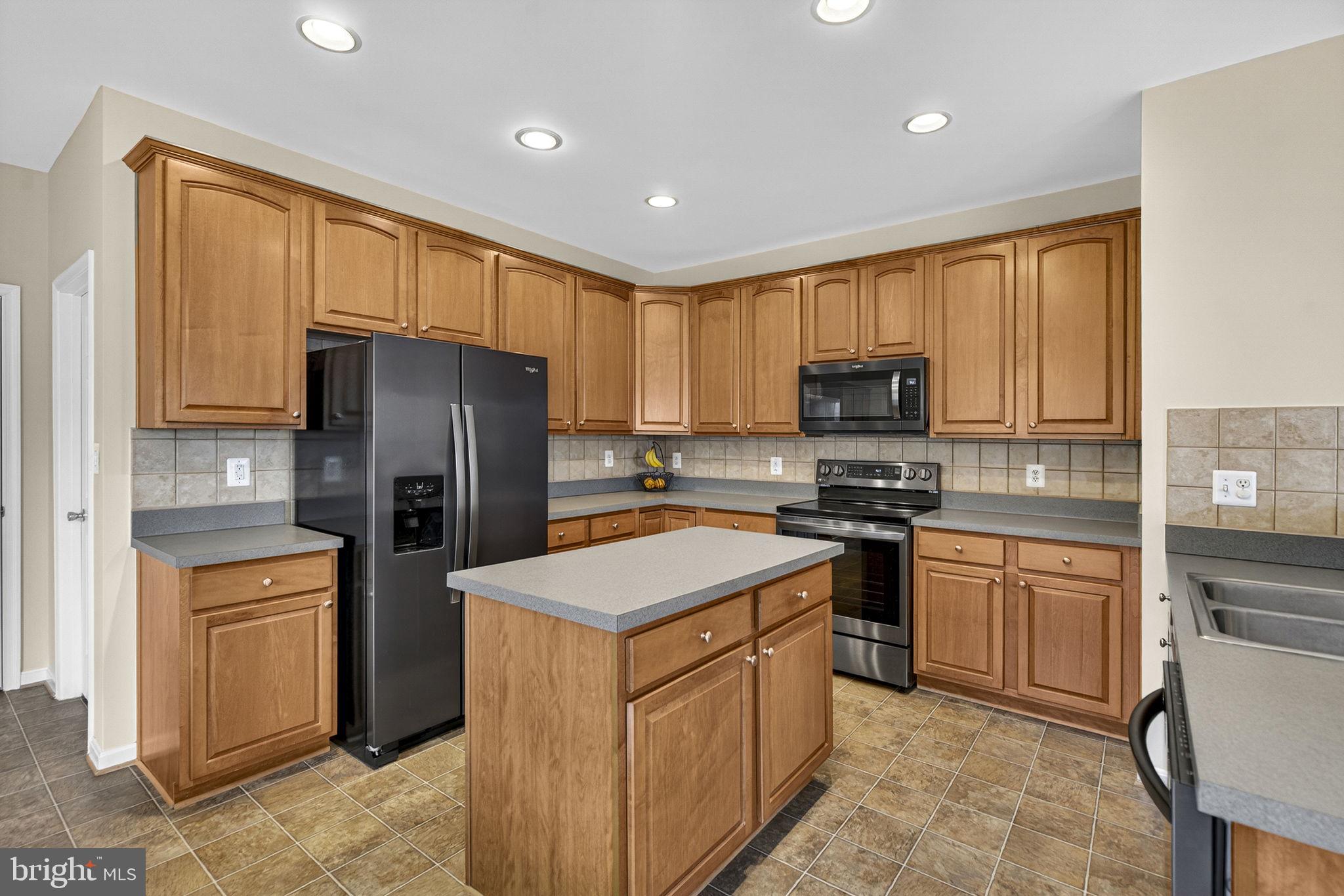 742 Blossom Tree Road Culpeper, VA 22701 - Photo 19 of 60 a kitchen with stainless steel appliances granite countertop a refrigerator stove microwave and sink