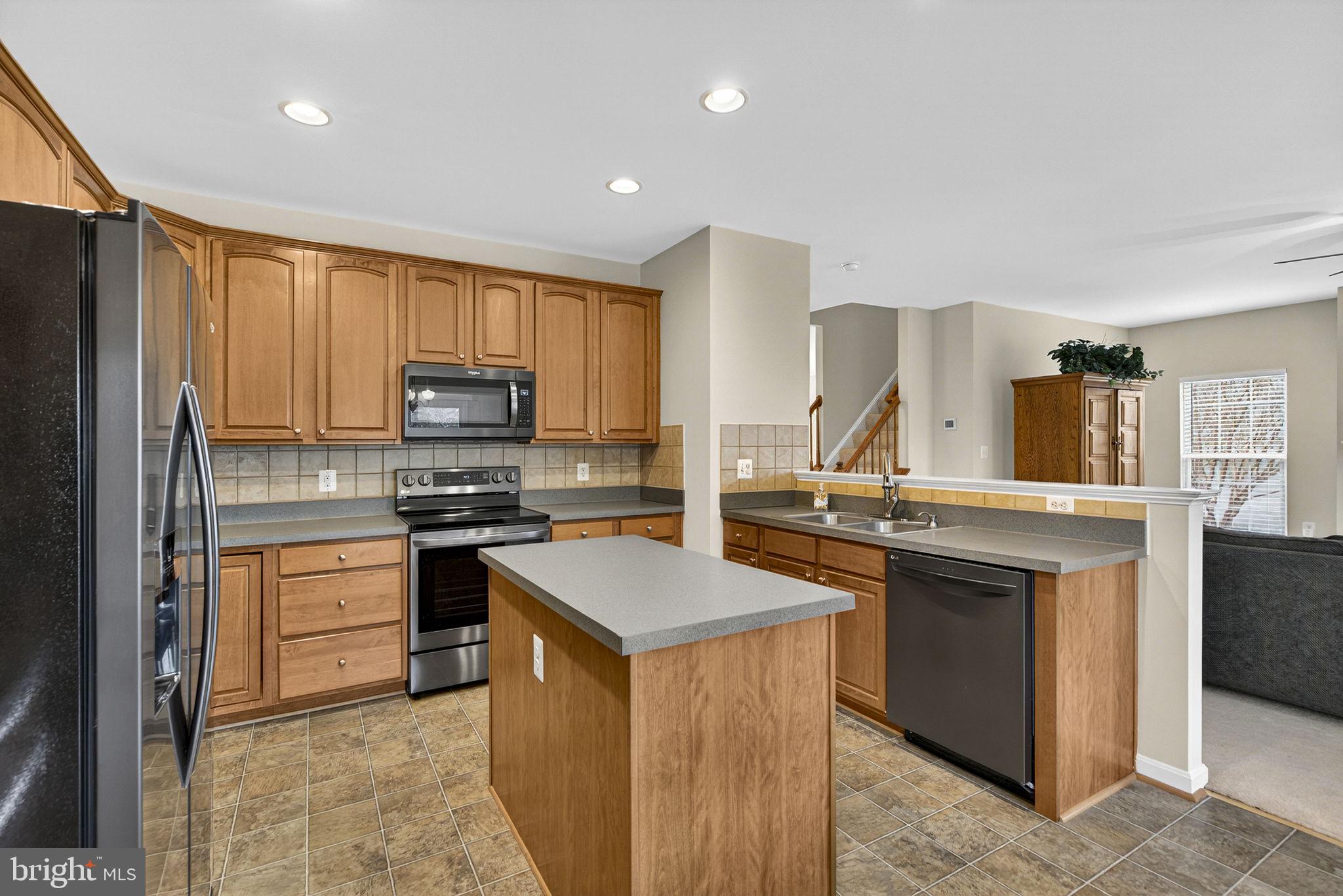 742 Blossom Tree Road Culpeper, VA 22701 - Photo 20 of 60 a kitchen with stainless steel appliances granite countertop a stove top oven a sink dishwasher and a refrigerator