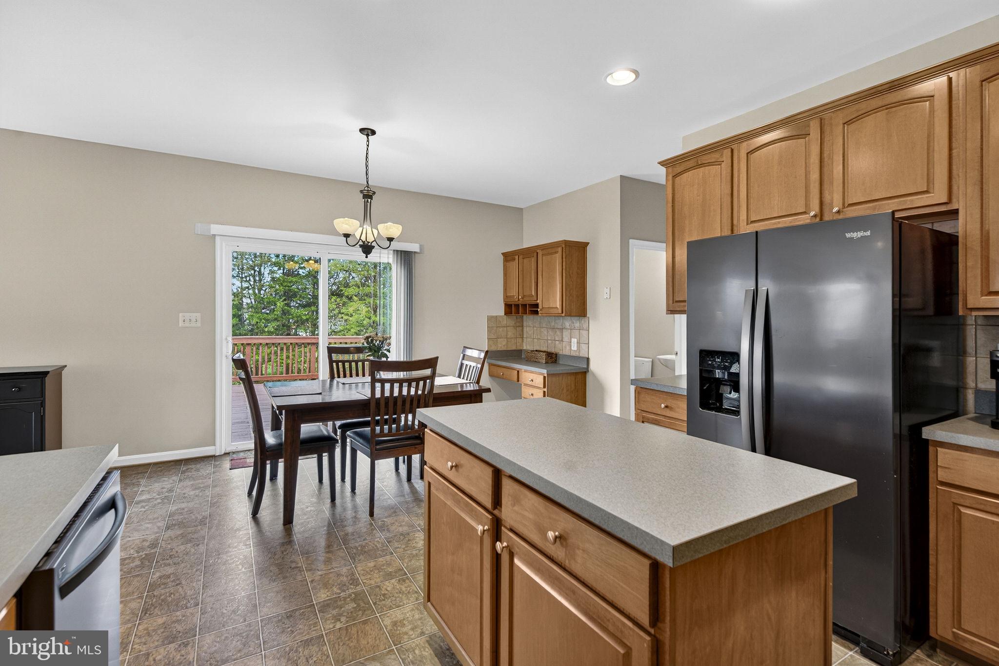 742 Blossom Tree Road Culpeper, VA 22701 - Photo 22 of 60 a kitchen with kitchen island a refrigerator stove dining table and chairs