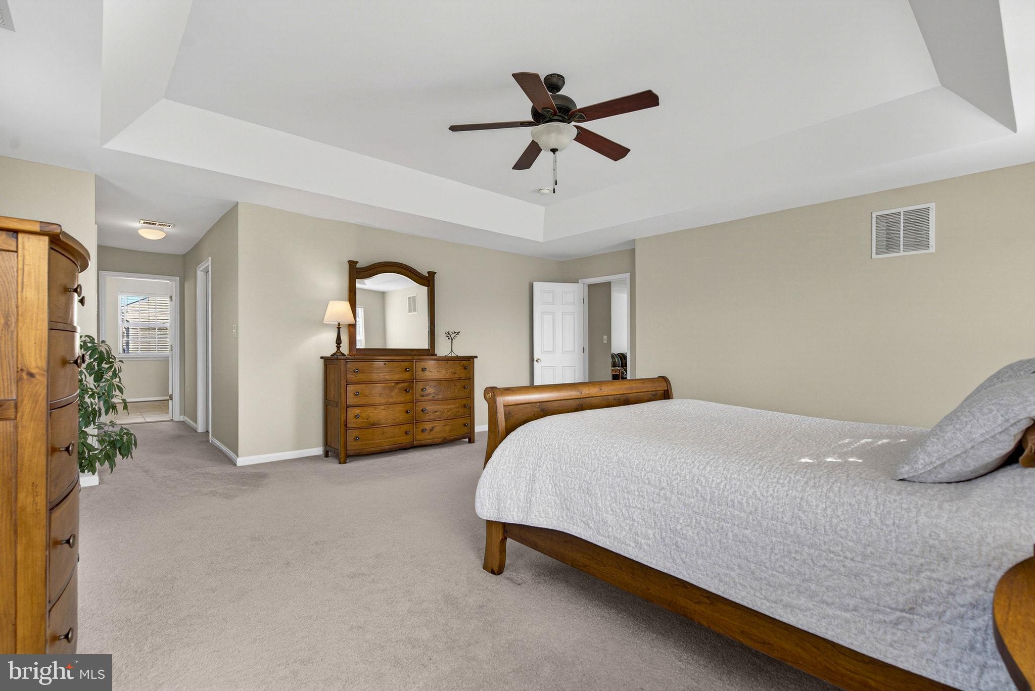 742 Blossom Tree Road Culpeper, VA 22701 - Photo 36 of 60 a bed room with a bed and a chandelier