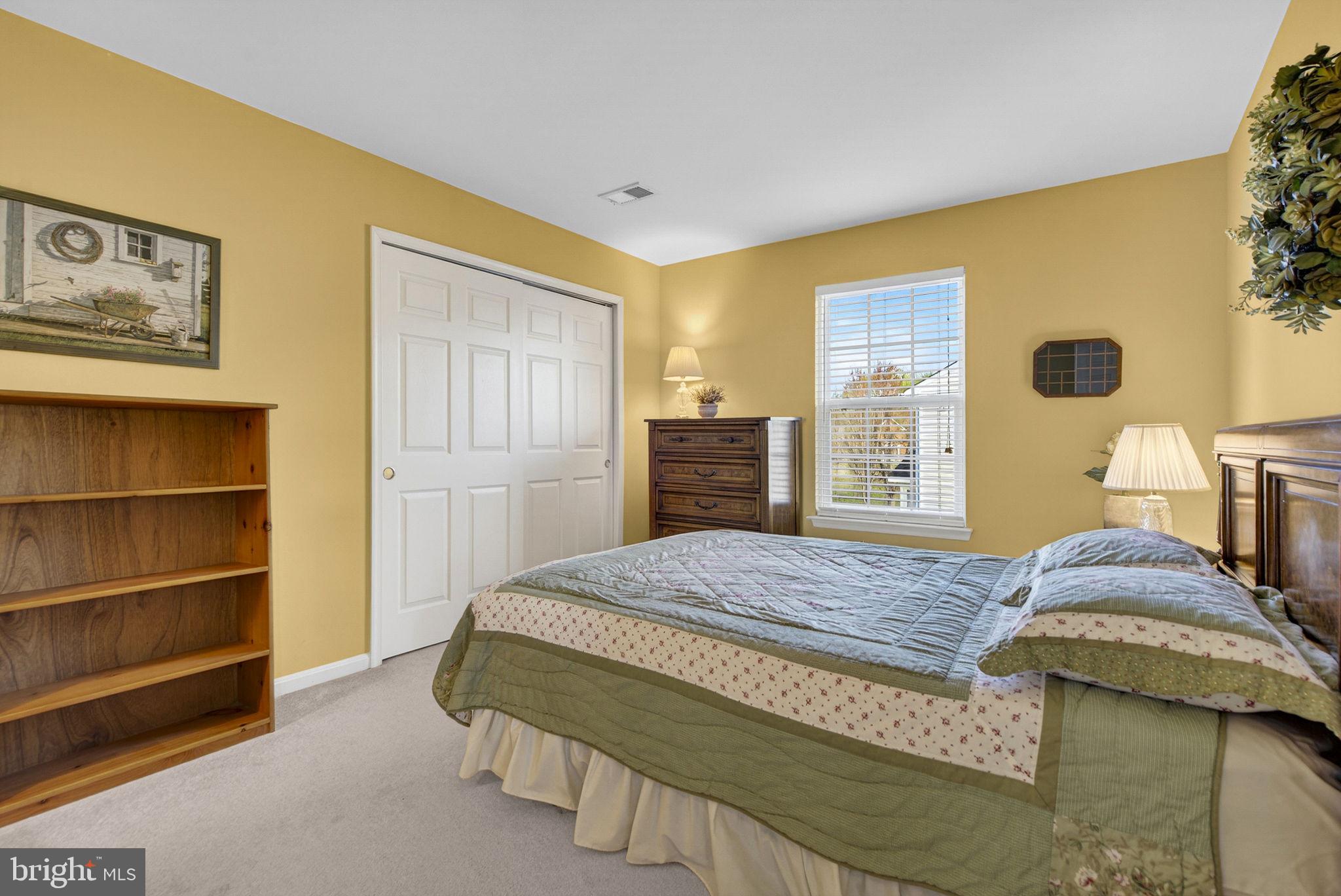 742 Blossom Tree Road Culpeper, VA 22701 - Photo 41 of 60 a bedroom with a bed and dresser with wooden floor
