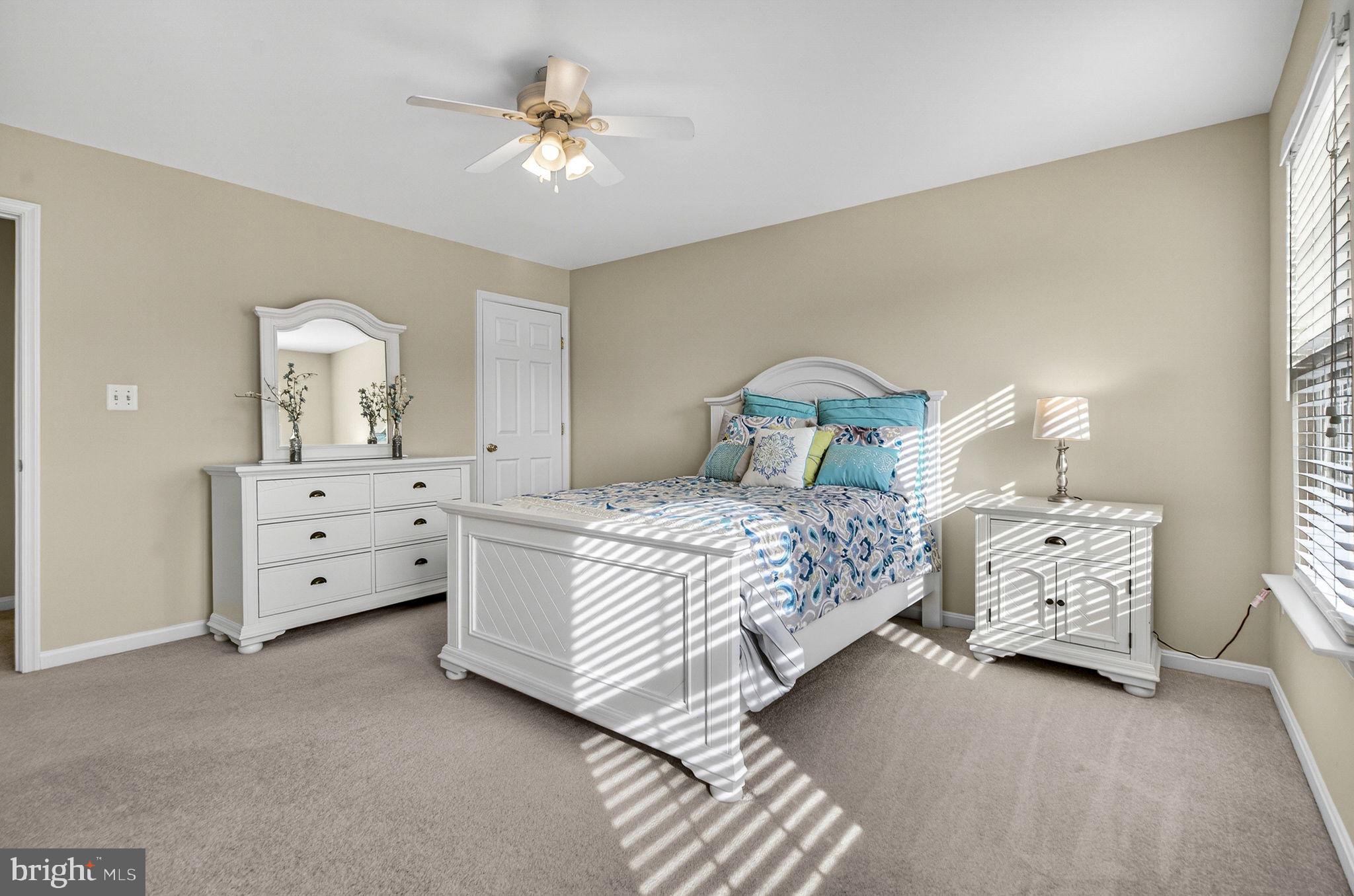 742 Blossom Tree Road Culpeper, VA 22701 - Photo 44 of 60 a bedroom with a bed and a chandelier