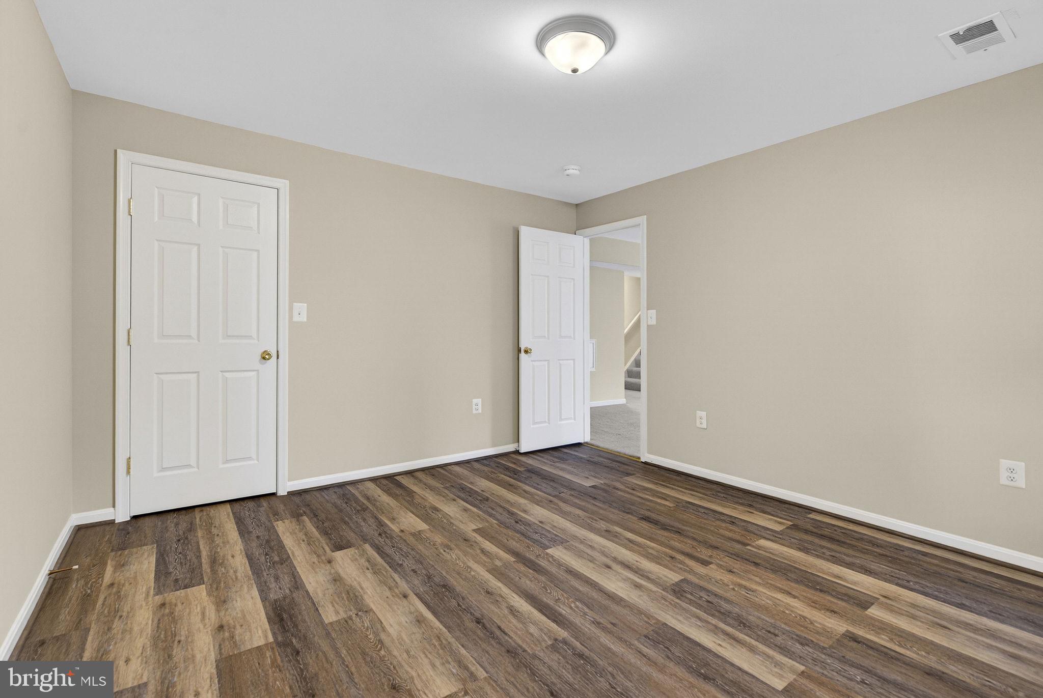 742 Blossom Tree Road Culpeper, VA 22701 - Photo 50 of 60 a view of an empty room with wooden floor