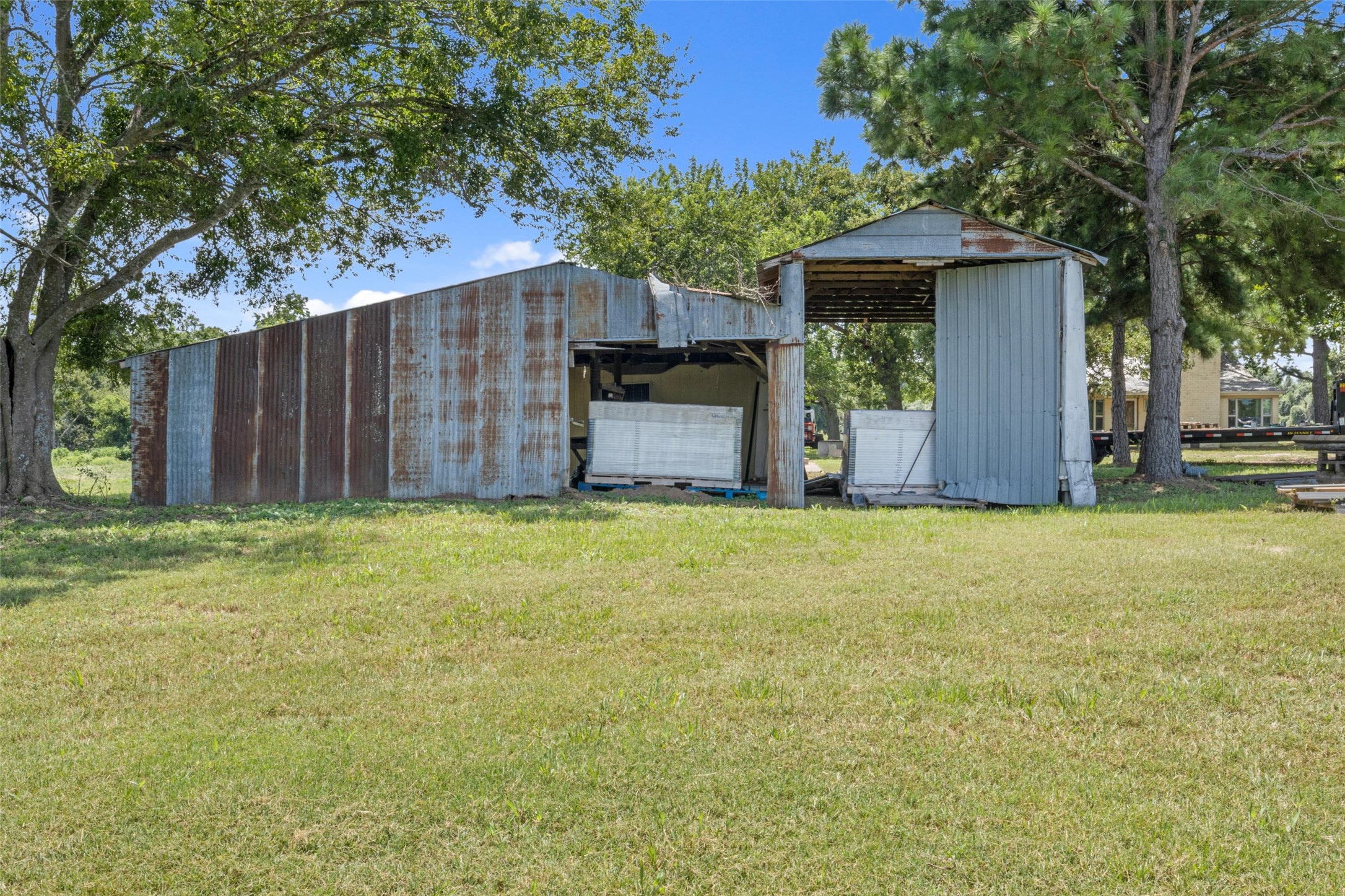 451 Pleasant Grove Road Elgin, TX 78621 - Photo 11 of 26 View of pole building featuring a yard