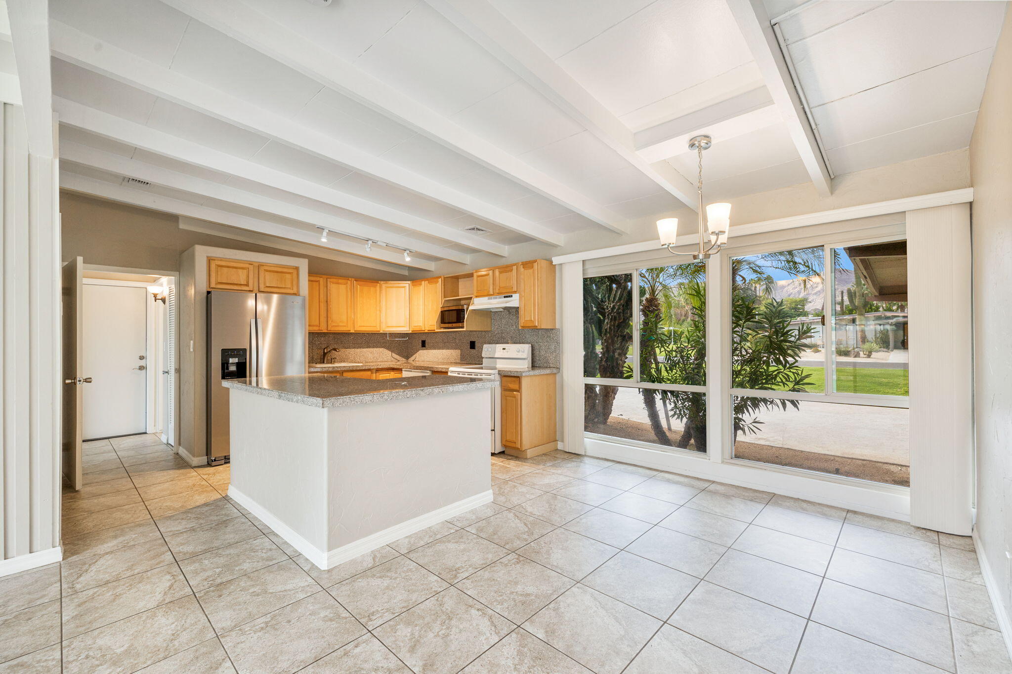 71996 Vista Del Rio Rancho Mirage, CA 92270 - Photo 13 of 39 a large white kitchen with a large window and kitchen view