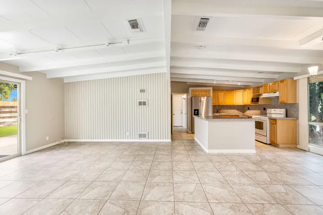 a view of a kitchen with microwave and refrigerator