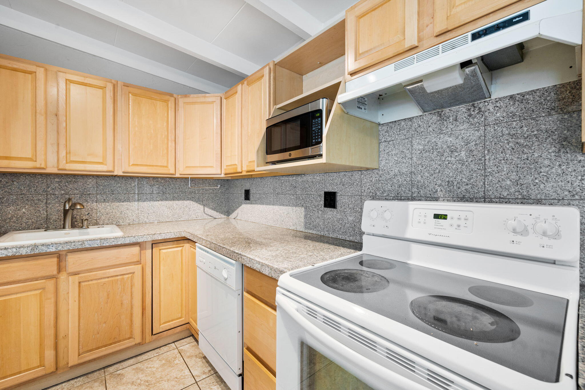 71996 Vista Del Rio Rancho Mirage, CA 92270 - Photo 10 of 39 a kitchen with a sink a stove and cabinets