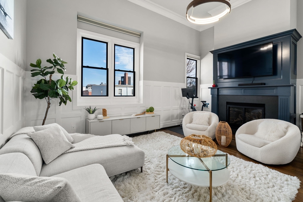44 High Street, Unit 7 Boston, MA 02129 - Photo 1 of 23 a living room with furniture a flat screen tv and a fireplace