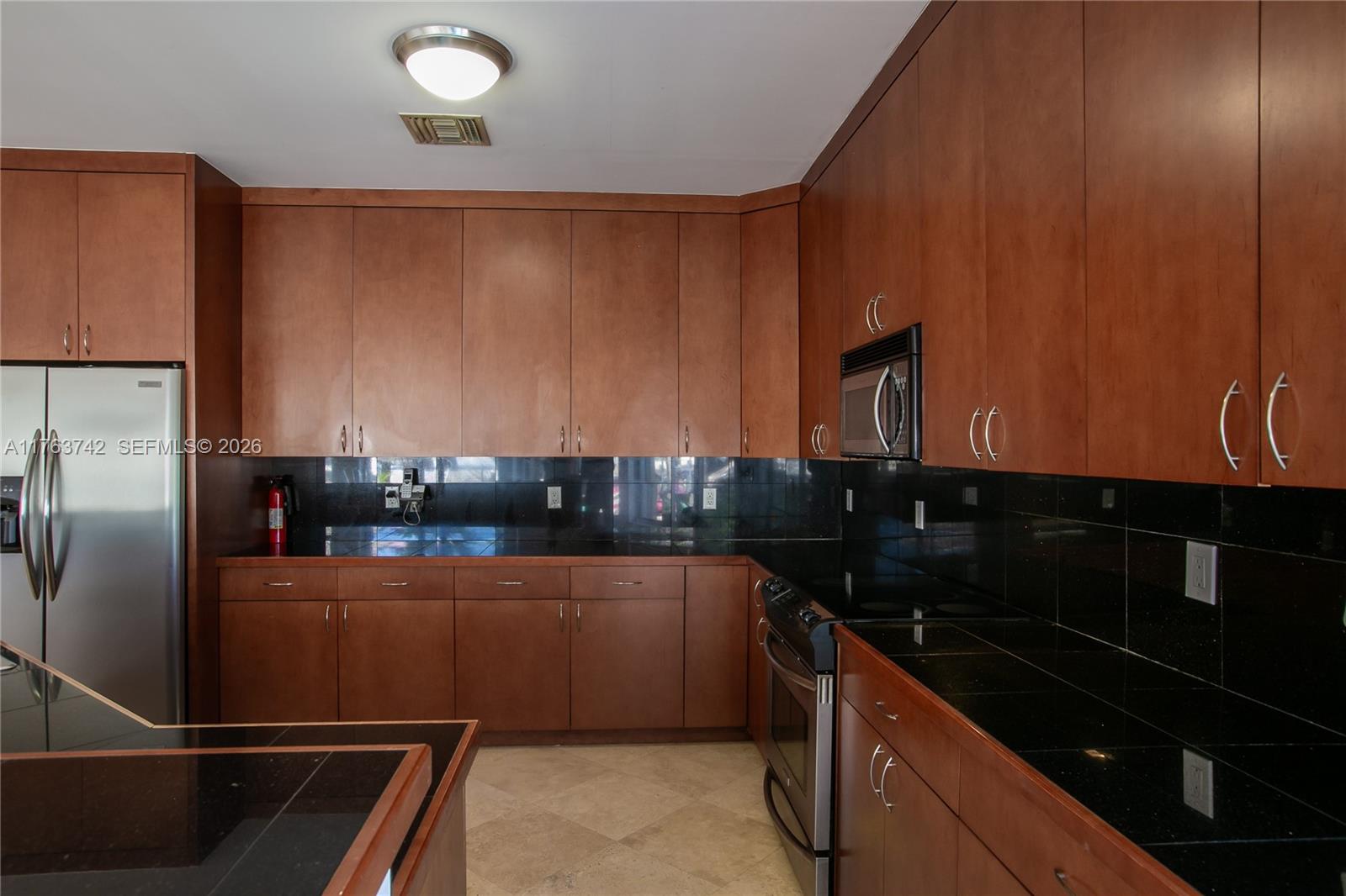 4750 Southwest 43rd Avenue Dania Beach, FL 33314 - Photo 11 of 28 a kitchen with granite countertop a refrigerator and a sink