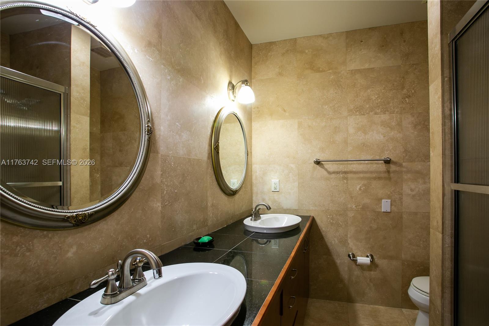 4750 Southwest 43rd Avenue Dania Beach, FL 33314 - Photo 18 of 28 a bathroom with a sink and a mirror