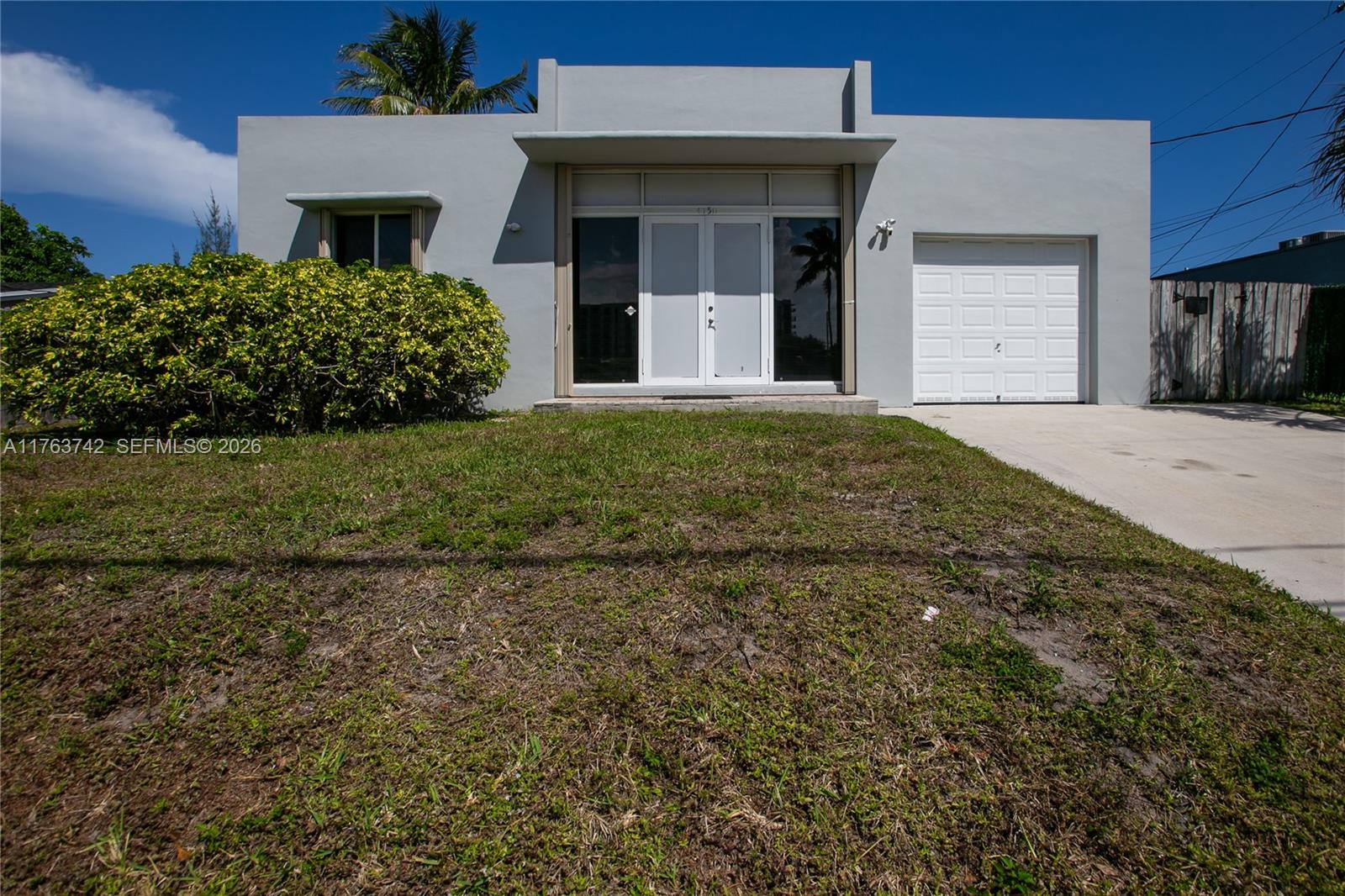 4750 Southwest 43rd Avenue Dania Beach, FL 33314 - Photo 3 of 28 a front view of a house with a garden