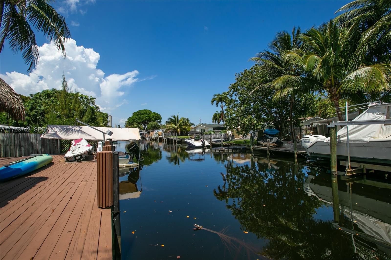 4750 Southwest 43rd Avenue Dania Beach, FL 33314 - Photo 5 of 28 a lake view with boat and palm trees