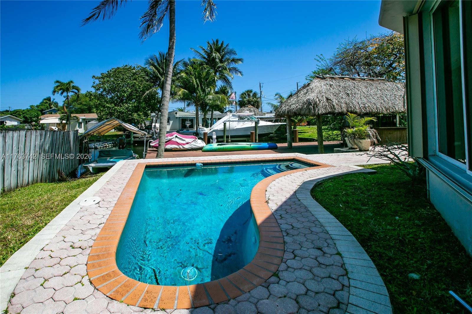 4750 Southwest 43rd Avenue Dania Beach, FL 33314 - Photo 6 of 28 a view of a swimming pool with a garden
