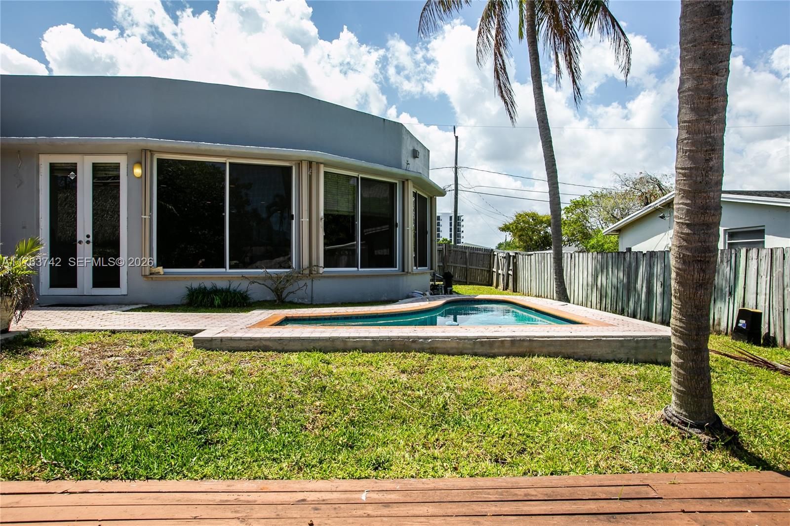 4750 Southwest 43rd Avenue Dania Beach, FL 33314 - Photo 7 of 28 a view of a house with a swimming pool and a yard