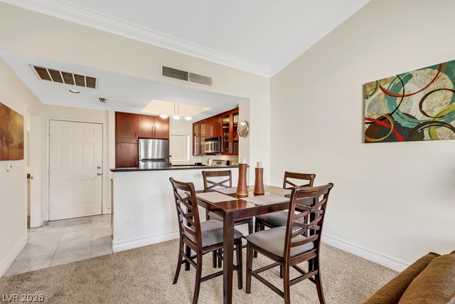 230 East Flamingo Road, Unit 435 Las Vegas, NV 89169 - Photo 6 of 15 A refined dining space effortlessly connects with the modern kitchen, ideal for entertaining.