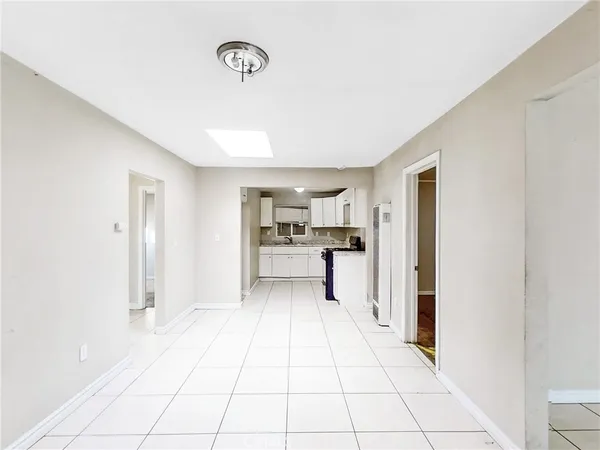 a view of a kitchen with a sink and a refrigerator