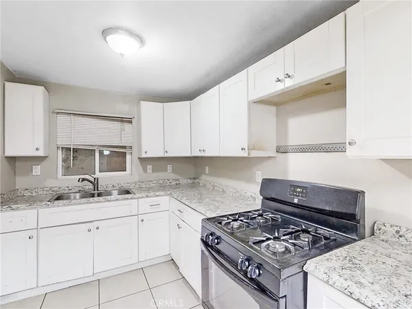a kitchen with a stove a sink and a refrigerator