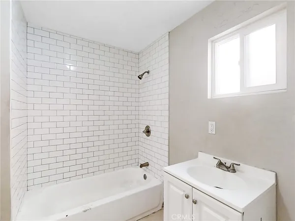 a bathroom with a sink a bathtub and a shower