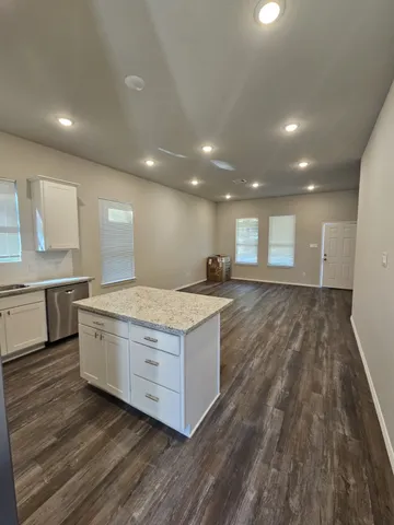 a kitchen with a stove and a wooden floors