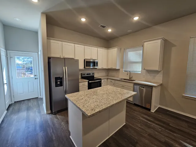 a kitchen with a refrigerator and a sink