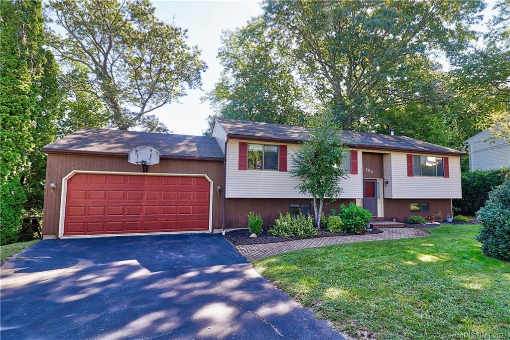 263 Juniper Ridge Drive Waterbury, CT 06708 - Photo 1 of 1 a front view of a house with a garden and garage