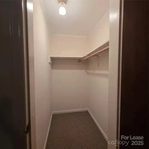 an empty room with closet and windows