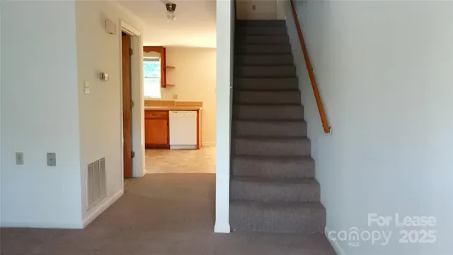 a view of a hallway with wooden floor and entryway